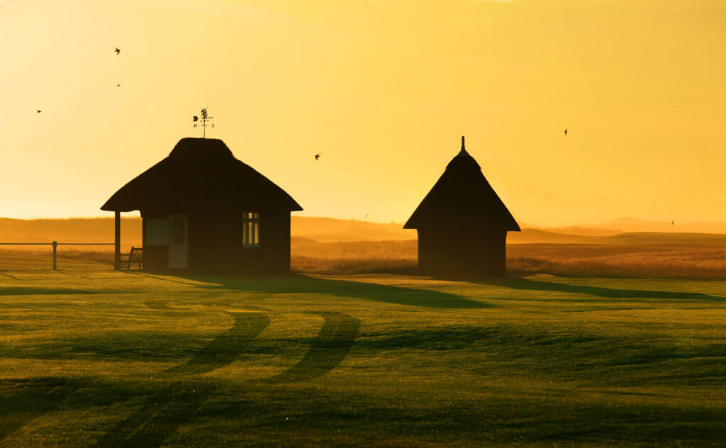 Fairway at sunset at Royal St George's Golf Club with huts