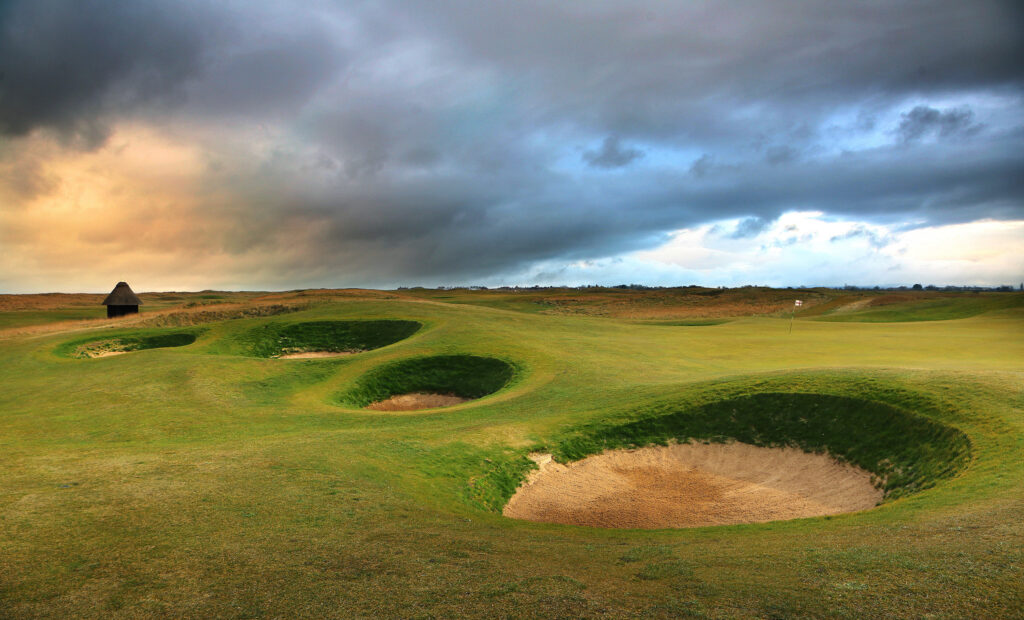 Hole with white flag with bunkers at Royal St George's Golf Club