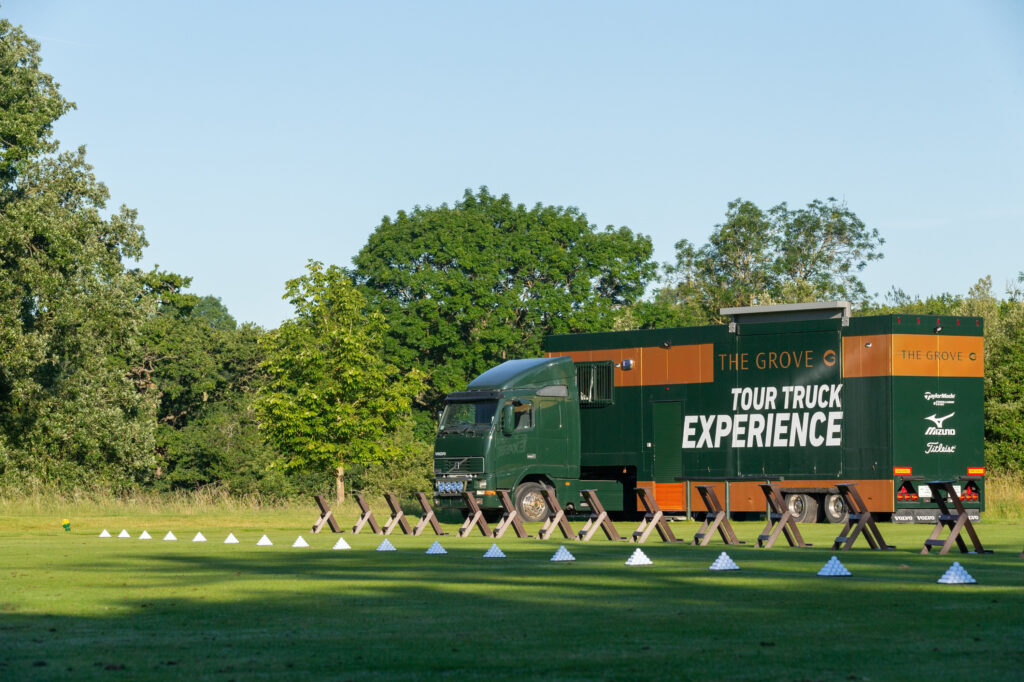 The Grove - Championship tour truck experience truck with driving range in foreground