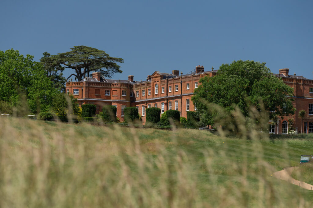 The Grove hotel with trees around and fairway in foreground