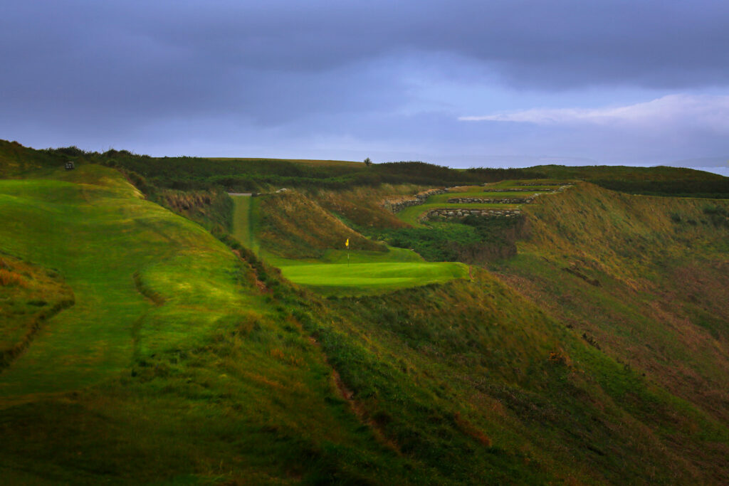 Hole with yellow flag on cliffside at Old Head Links