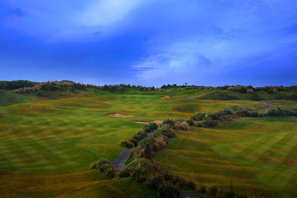 Aerial view of fairway with bunkers leading to hole with yellow flag at Old Head Links