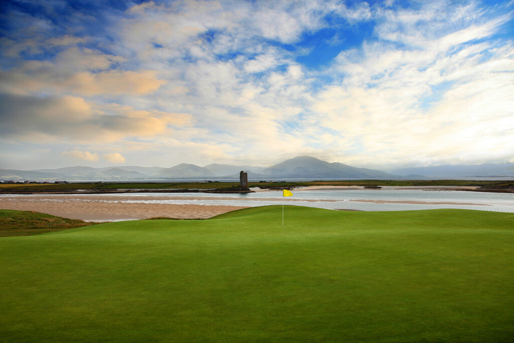 Hole with yellow flag at Tralee Golf Club with ocean view