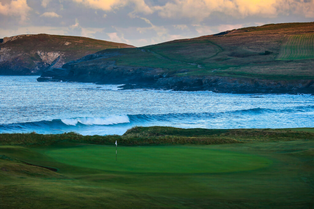 Hole with ocean in background at Championship Course at Trevose Golf & Country Club