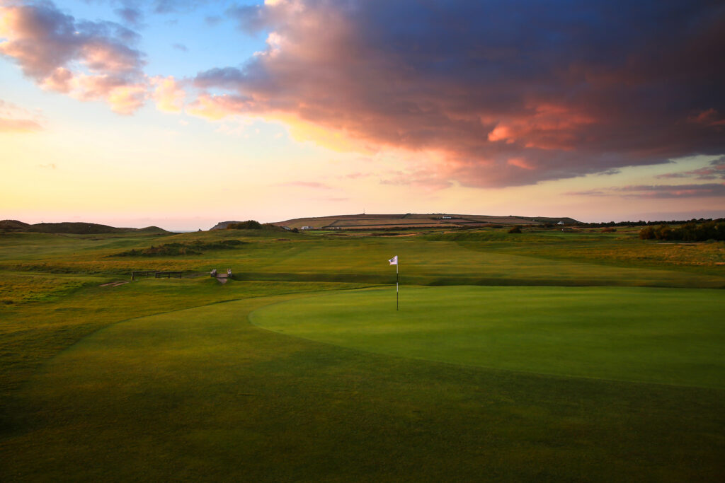 Hole with white flag and fairway in background at Championship Course at Trevose Golf & Country Club