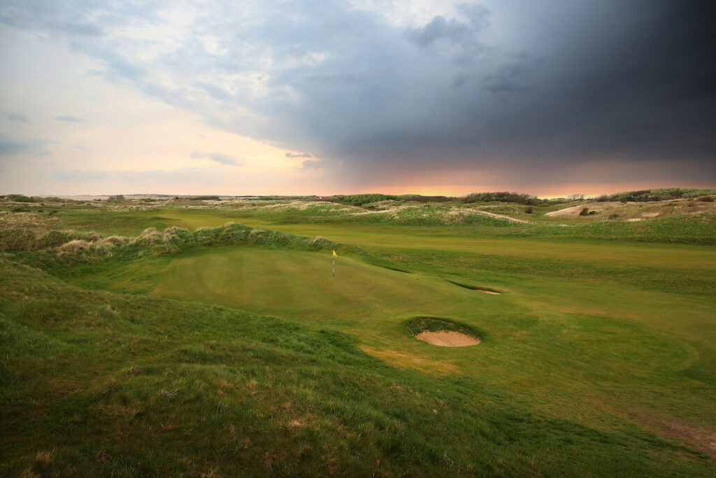 Hole with yellow flag at West Lancashire Golf Club