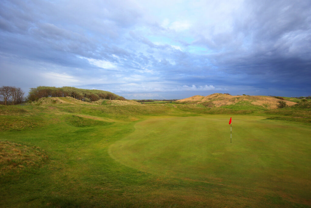 Hole with red flag at West Lancashire Golf Club