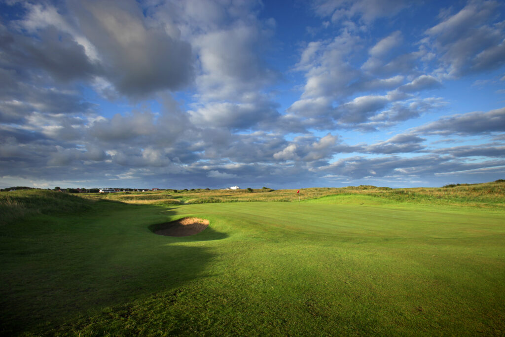 Hole with red flag and bunkers at West Lancashire Golf Club