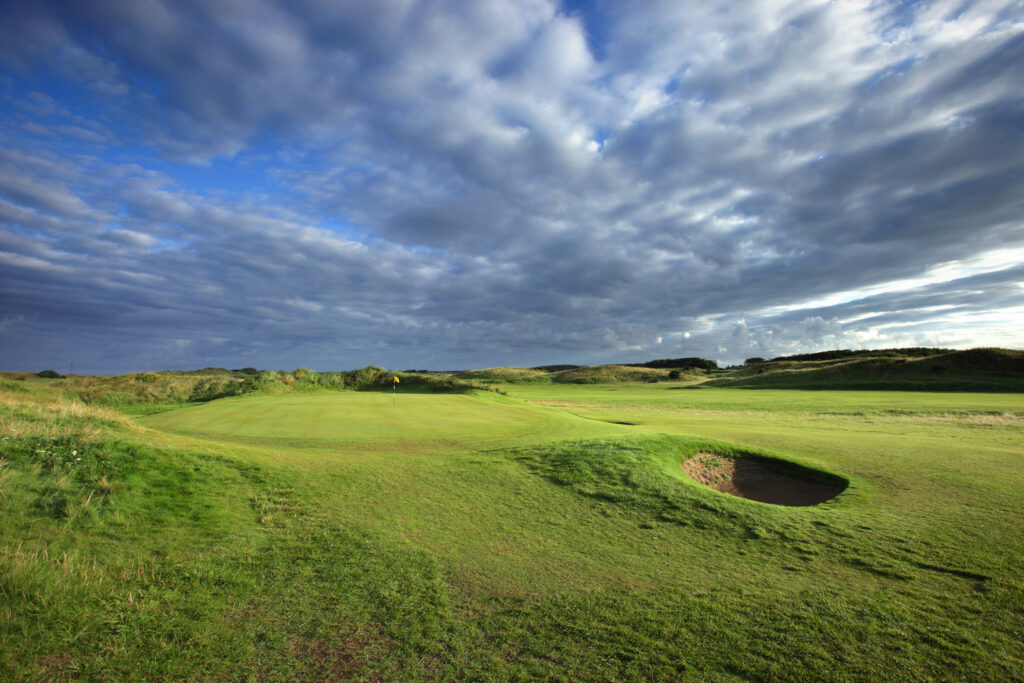 Hole with yellow flag with bunkers at West Lancashire Golf Club