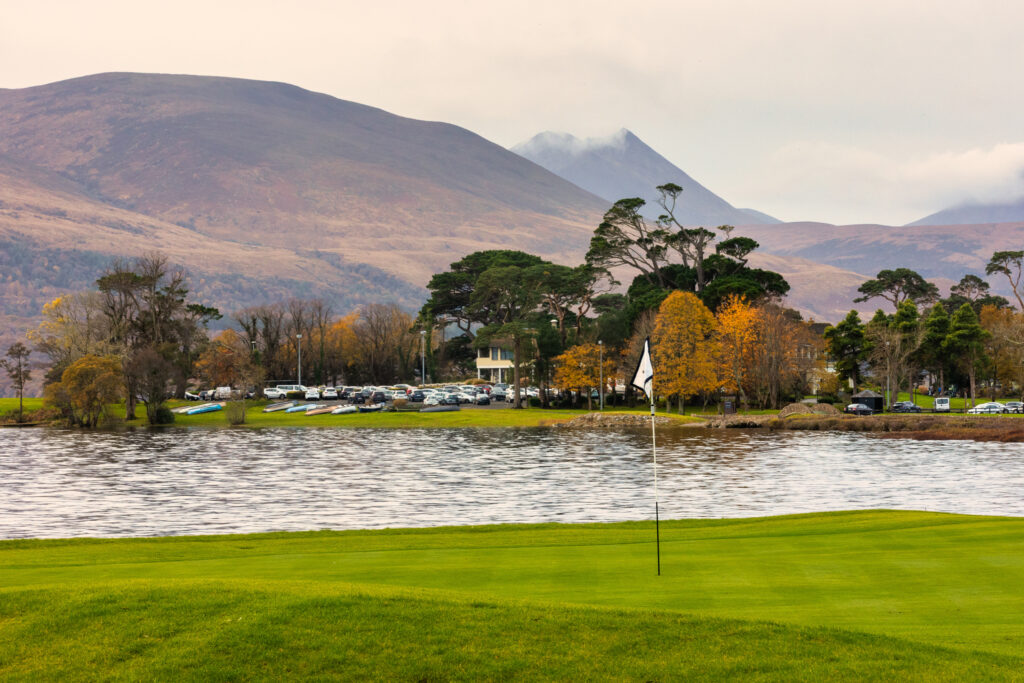 Hole at Killarney Golf & Fishing Club - Killeen Course with lake view and hills in distance