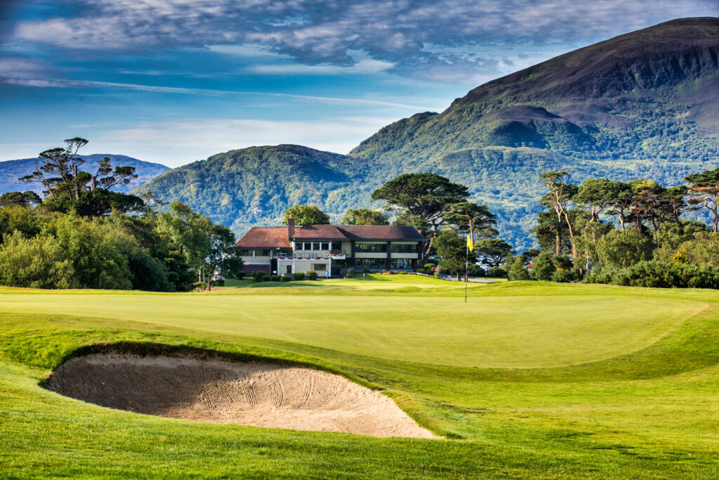 Hole with bunker at Killarney Golf & Fishing Club - Killeen Course with building in background