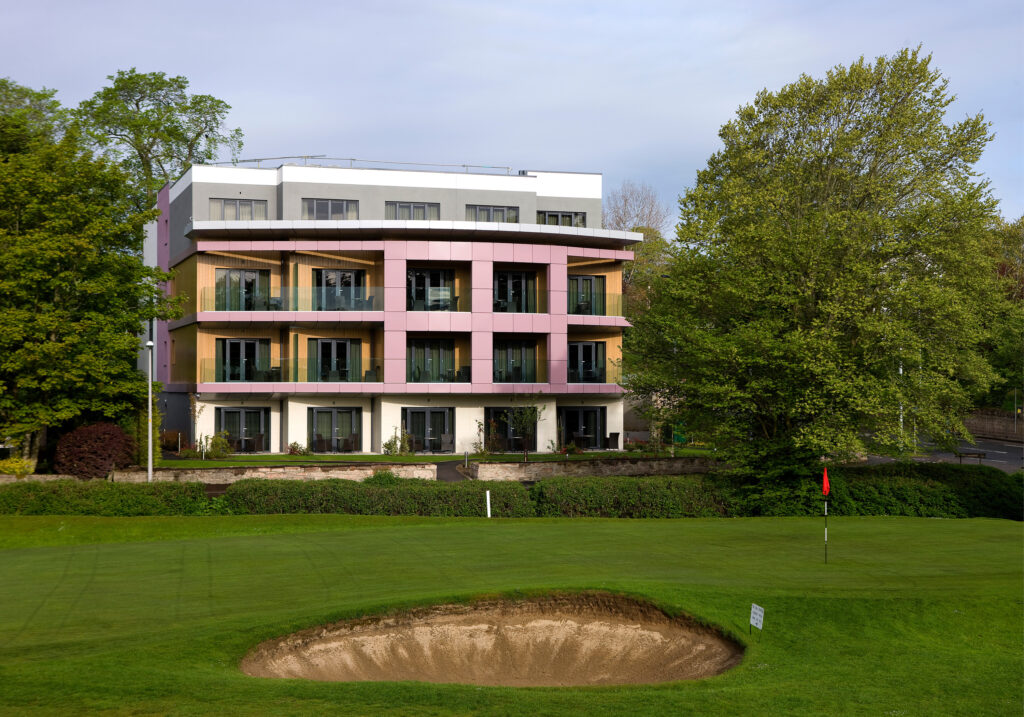 Golf at Kingsmills Hotel with a building in background