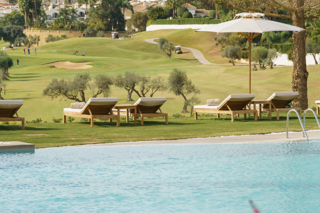 Outdoor pool with loungers at La Zambra Resort