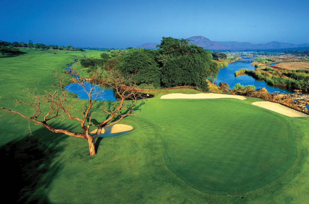 Hole with bunkers and trees around at Leopard Creek Country Club with creek running next to it