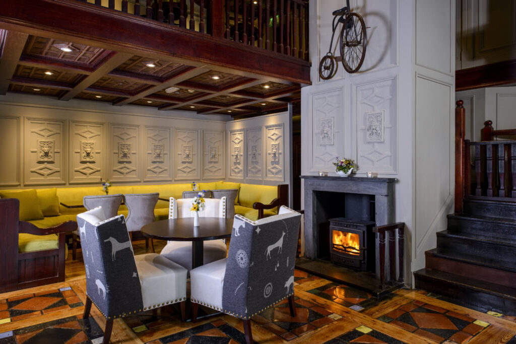 Seating area by a wood burner at Meadowlands Hotel