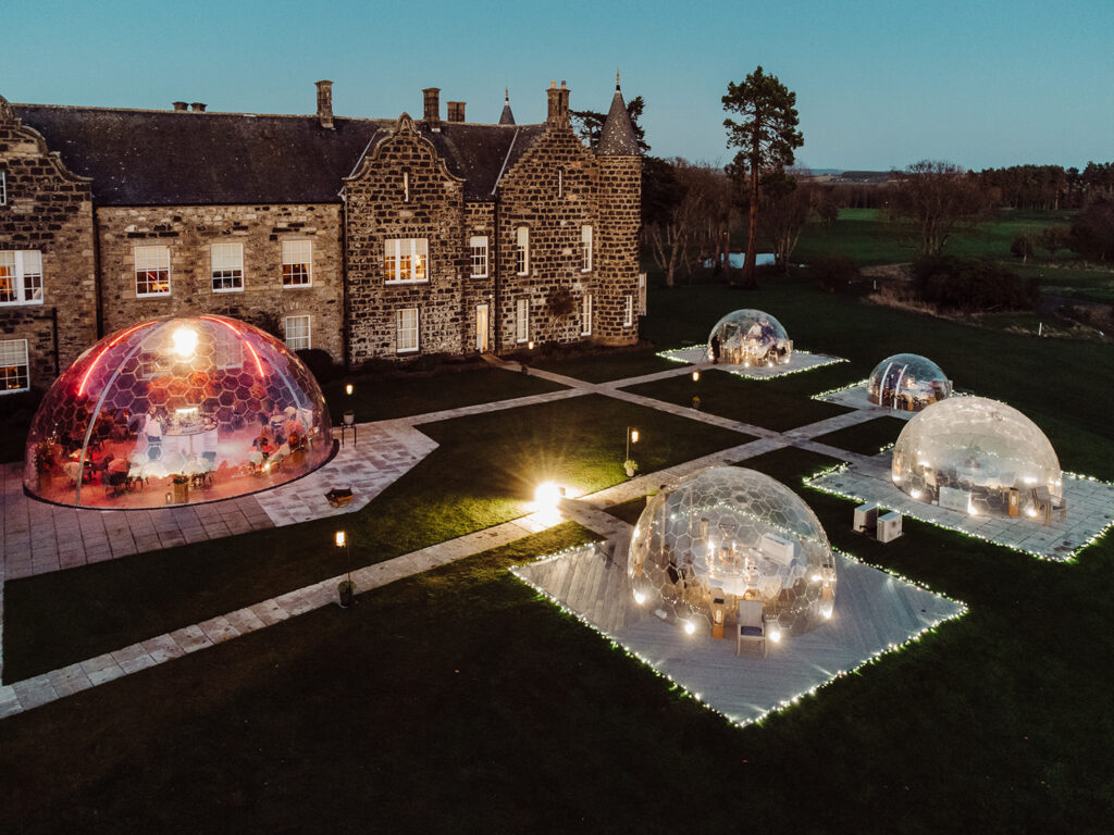 Exterior of Meldrum House Country Hotel & Golf Course with outdoor dining domes