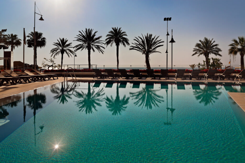 Outdoor pool with loungers at Melia Costa Del Sol