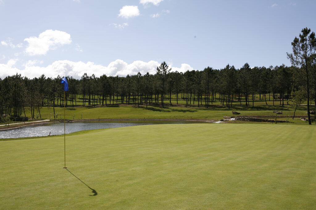 golf course with a lake in the background