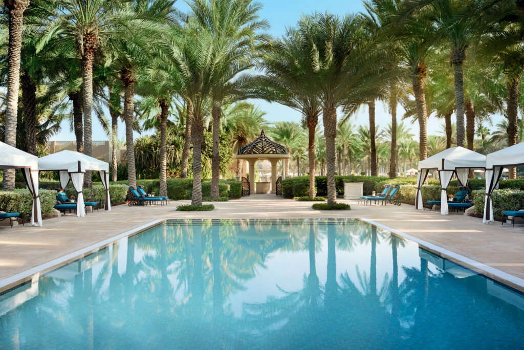 Outdoor pool at One & Only Royal Mirage Dubai Jumeirah with palm trees around