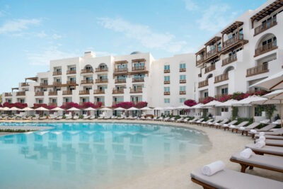 Exterior of Park Hyatt Dubai with outdoor pool and loungers