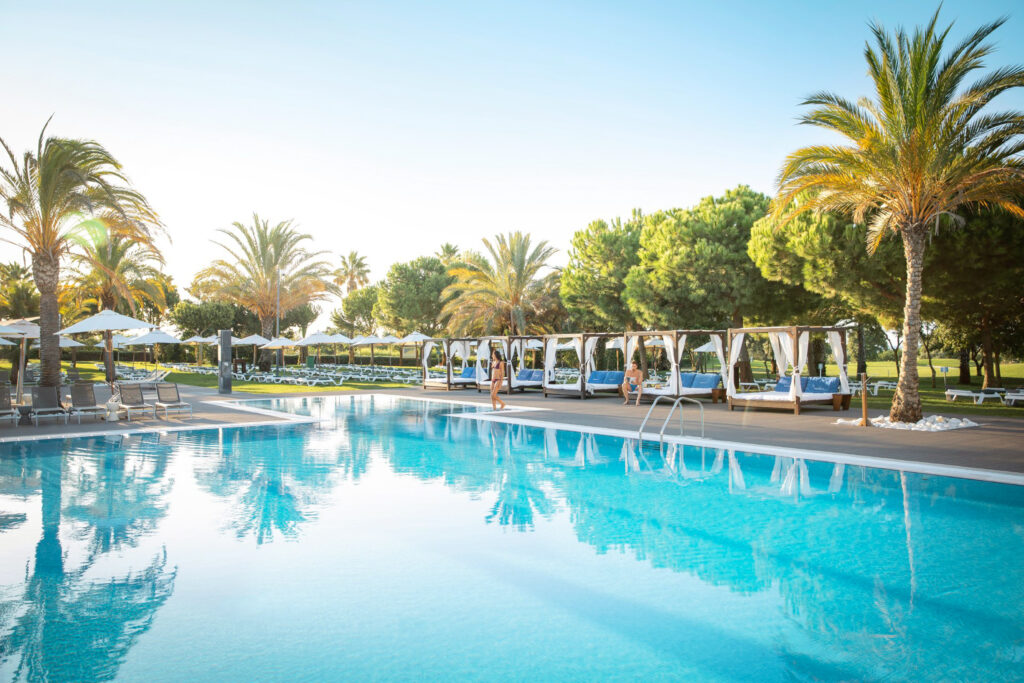 Outdoor pool with canopy beds at Robinson Club Quinta da Ria