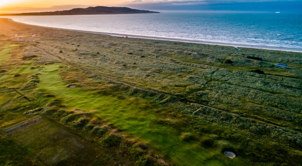 Aerial view of the fairway at Royal Dublin Golf Club with ocean in background