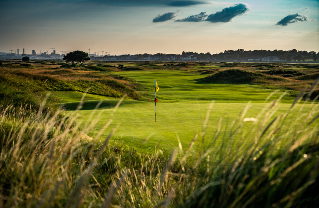 Hole with yellow flag at Royal Dublin Golf Club