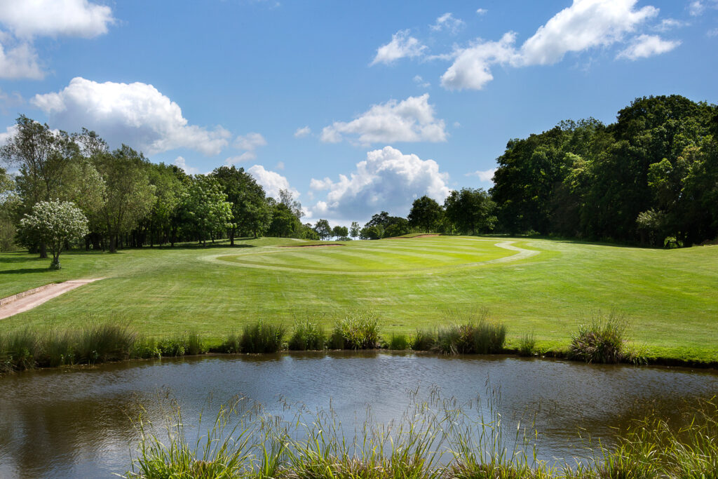 Lake on fairway at Sandford Springs with trees around