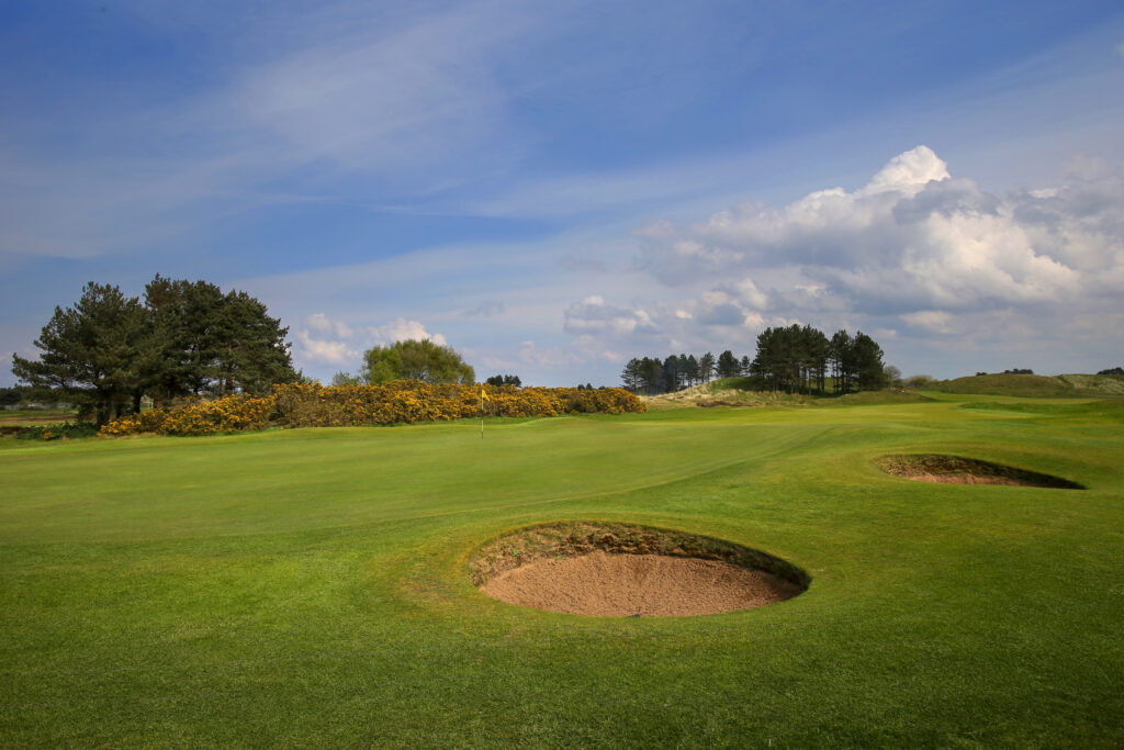 Hole with bunkers at Southport & Ainsdale with trees in background