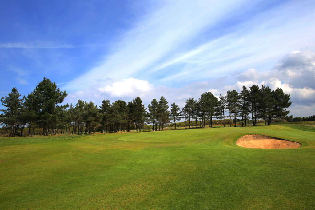 Hole with bunker at Southport & Ainsdale with trees in background