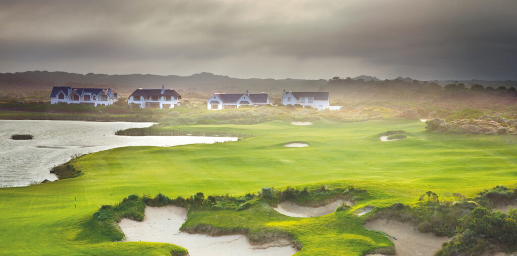 Bunkers on fairway at St Francis Links Golf Club with buildings in background