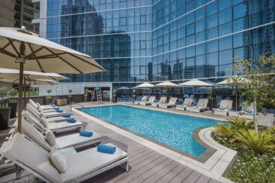 Outdoor pool at TRYP by Wyndham Dubai with loungers around