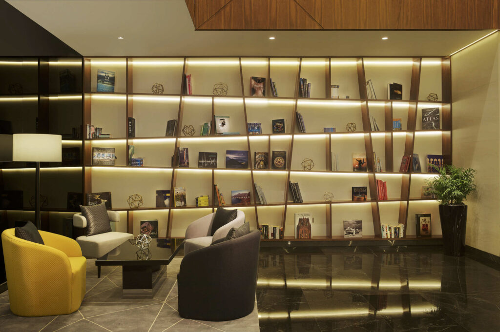 Indoor seating area with bookshelf at TRYP by Wyndham Dubai