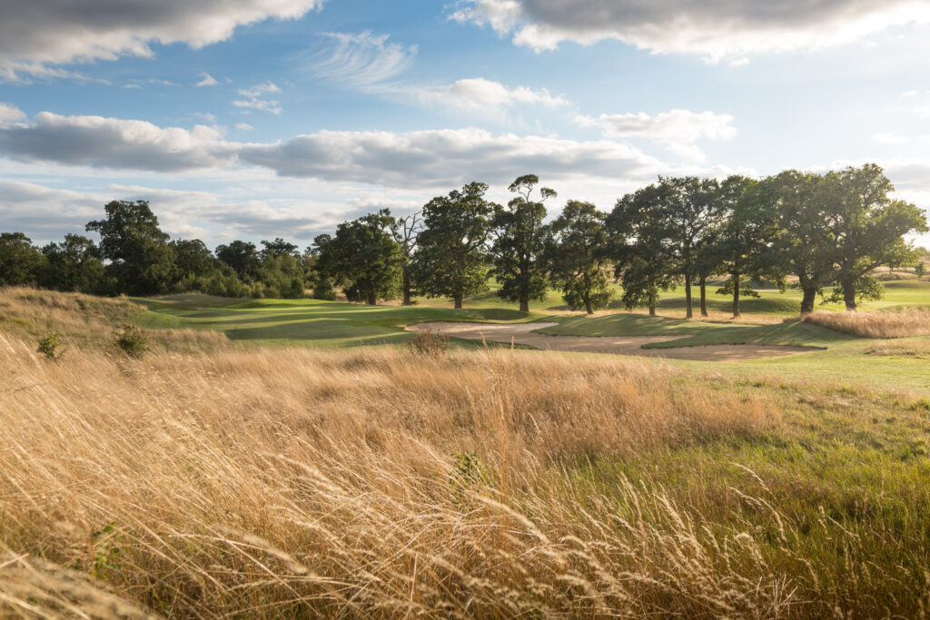 Fairway leading to hole with bunkers and trees around at The Oxfordshire