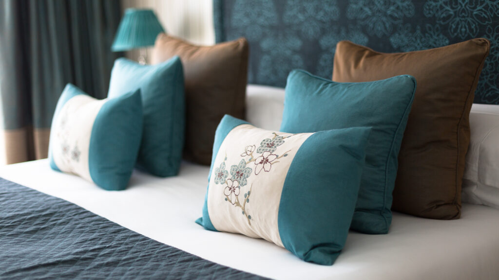 Double bed at The Oxfordshire Hotel and Spa with patterned cushions