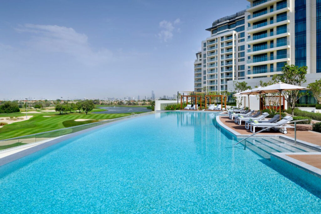 Outdoor pool at Vida Emirates Hills with view of the golf course