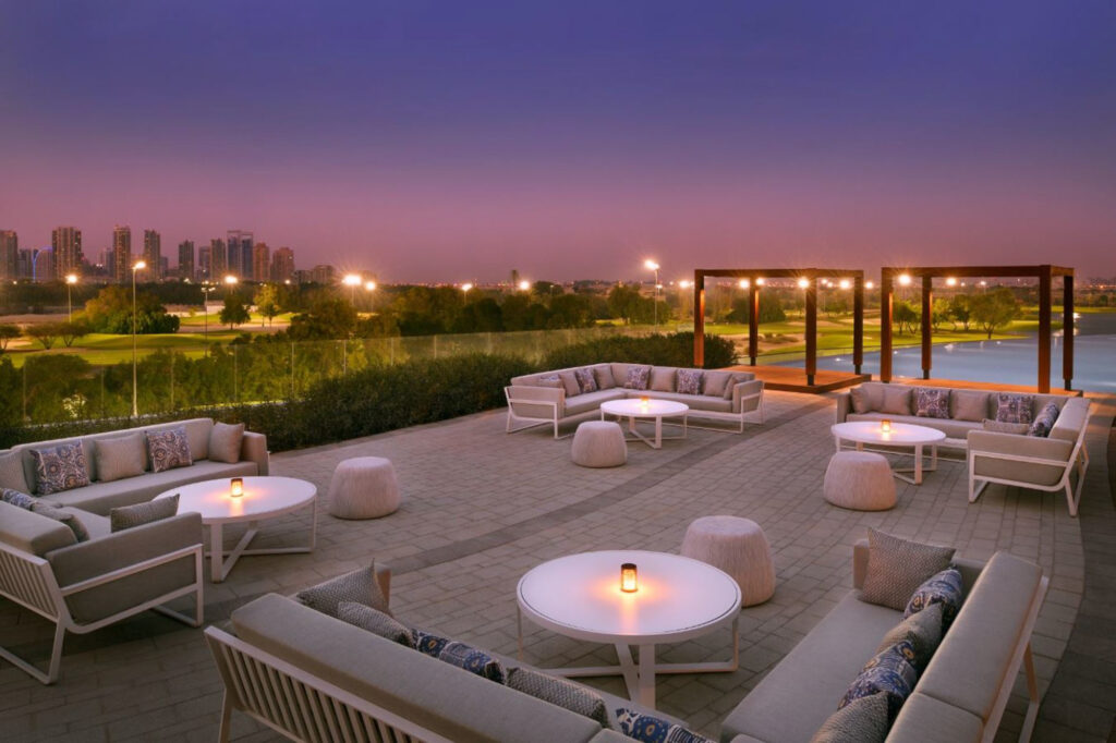 Outdoor seating area at Vida Emirates Hills at night