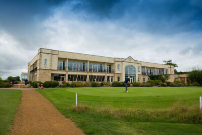 Building at Whittlebury Park Golf Course with person using the putting green