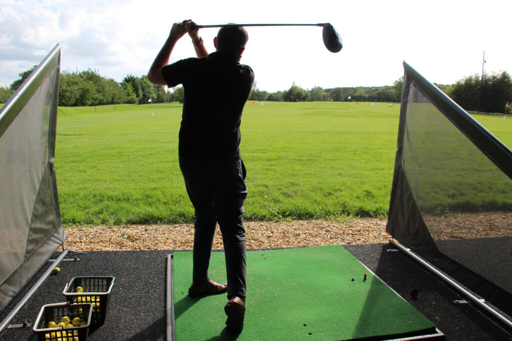 Person playing golf at the driving range at Whittlebury Park Golf Course