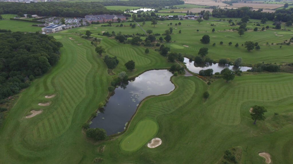 Aerial view of Whittlebury Park Golf Course with a lake