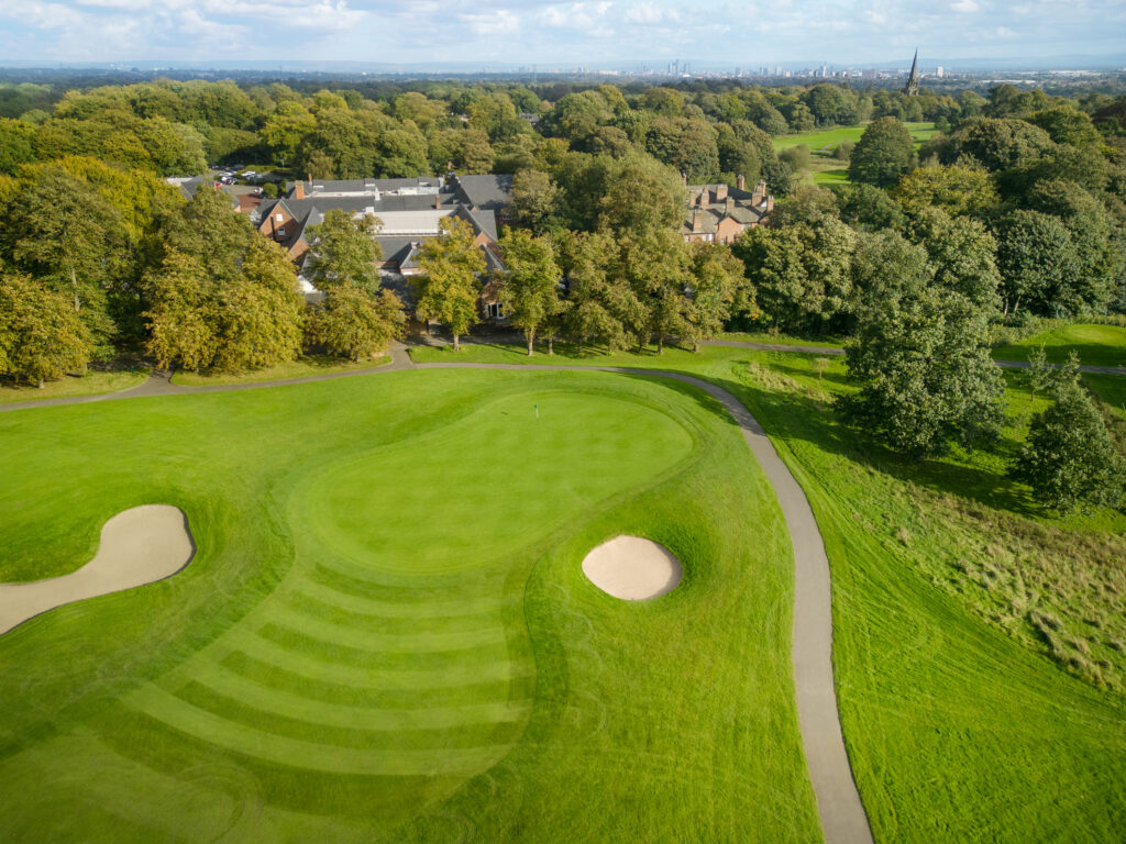 Aerial view of a hole at Worsley Park Golf Course with bunkers and trees around