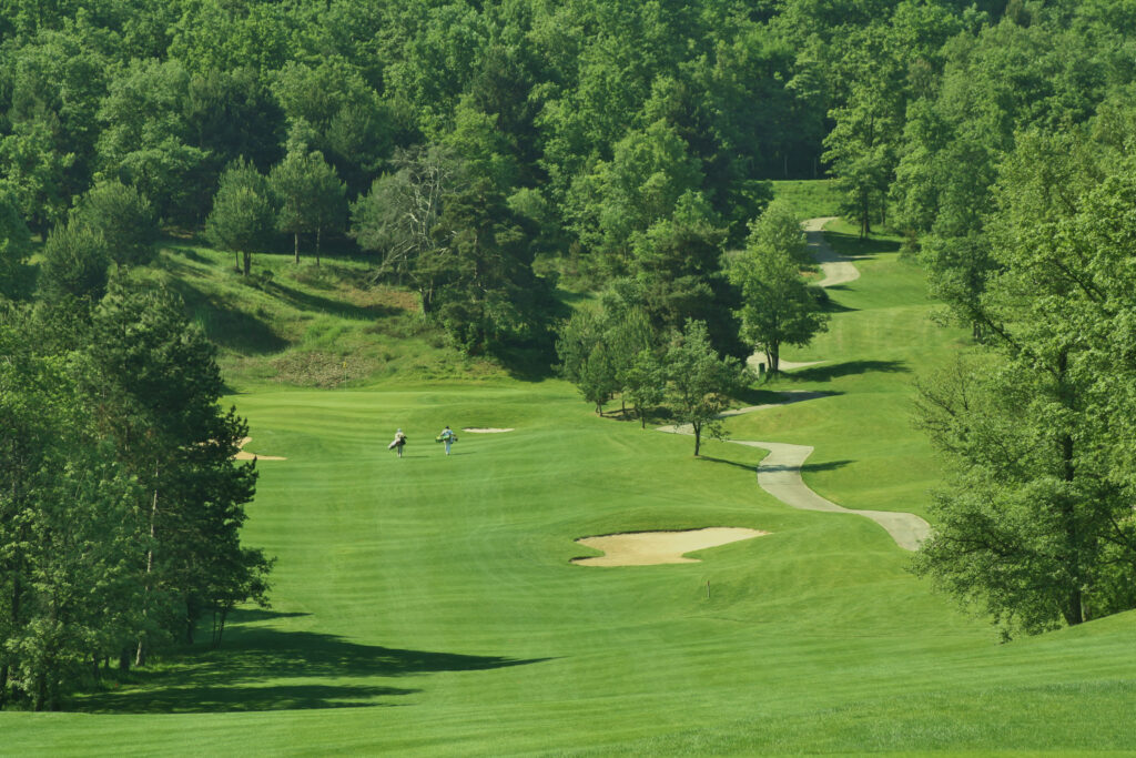 People walking through the fairway at Club de Campo Sojuela with trees around