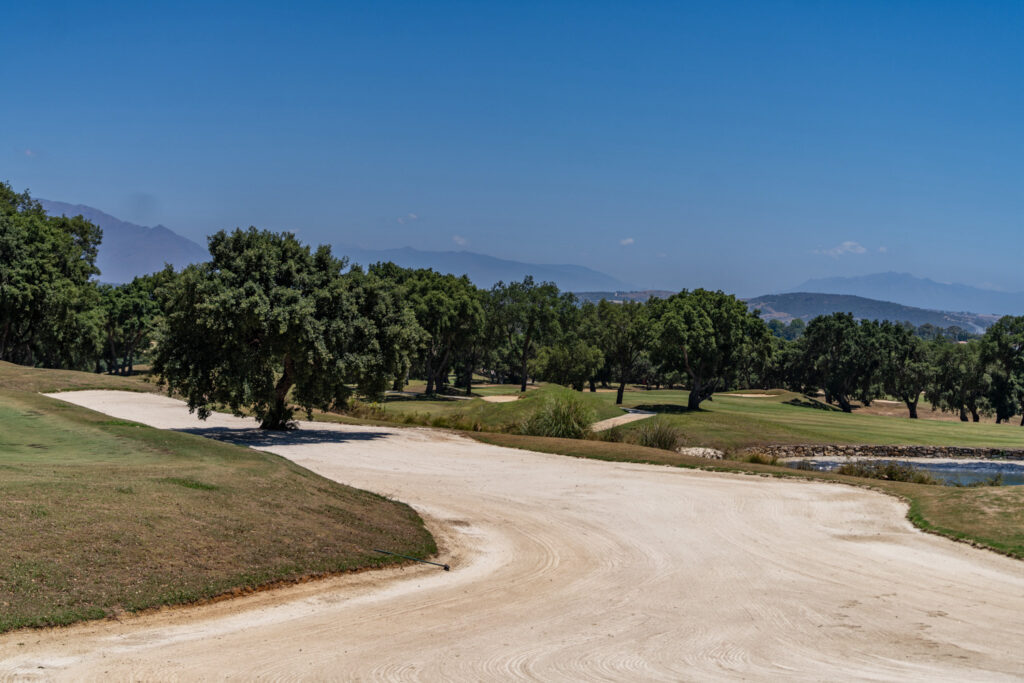 Bunker on fairway at San Roque Golf & Resort with trees around