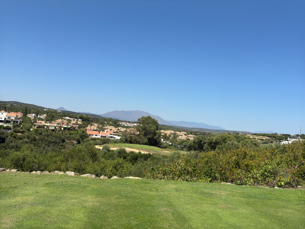 Fairway with trees and buildings in distance at San Roque Golf & Resort