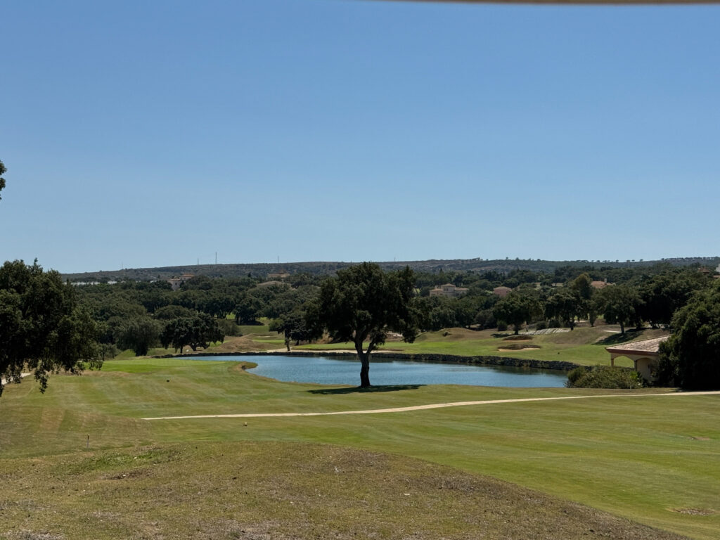 Fairway with trees and lake in background at San Roque Golf & Resort