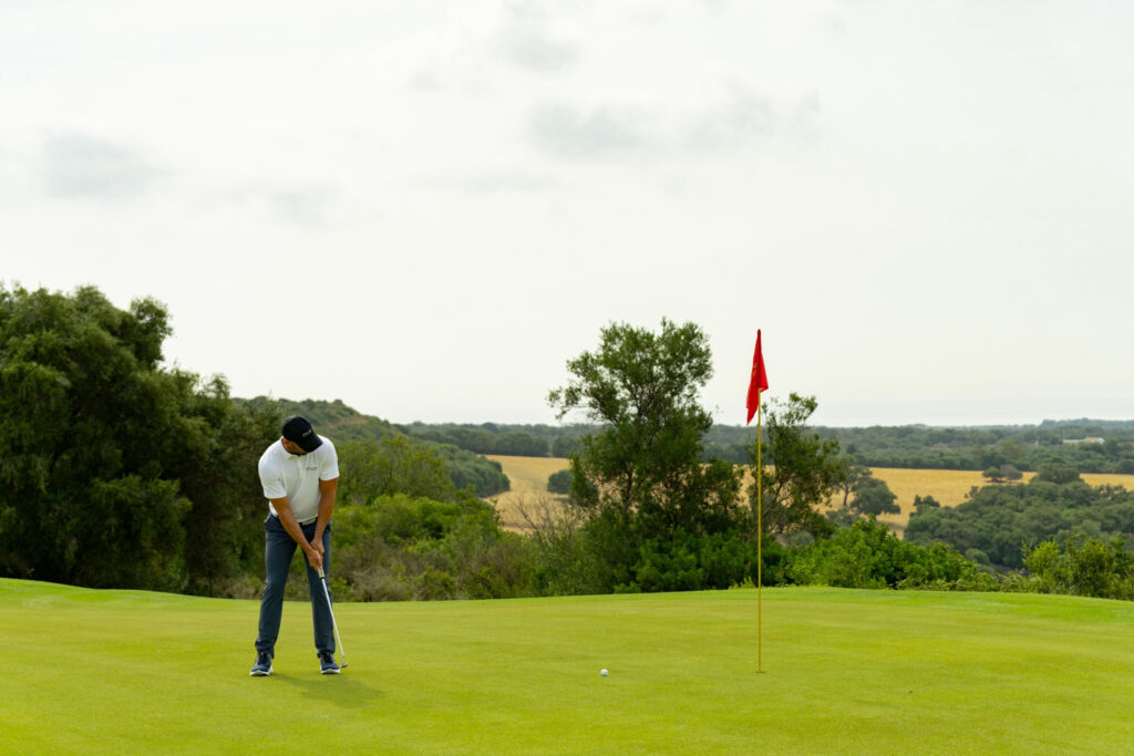 Person putting at San Roque Golf & Resort