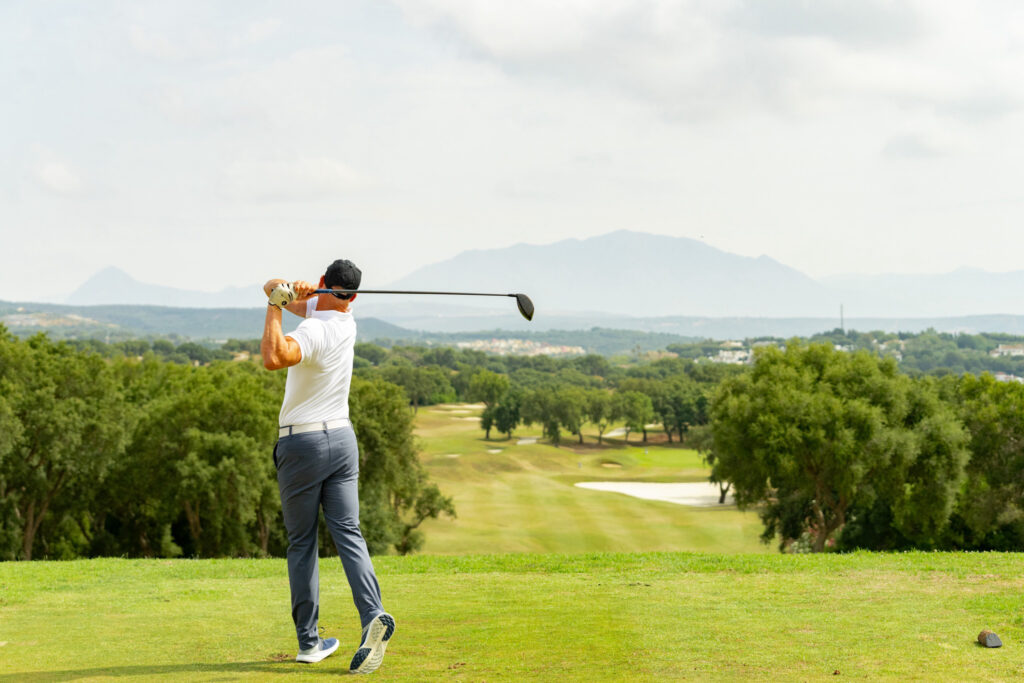 Person teeing off at San Roque Golf & Resort