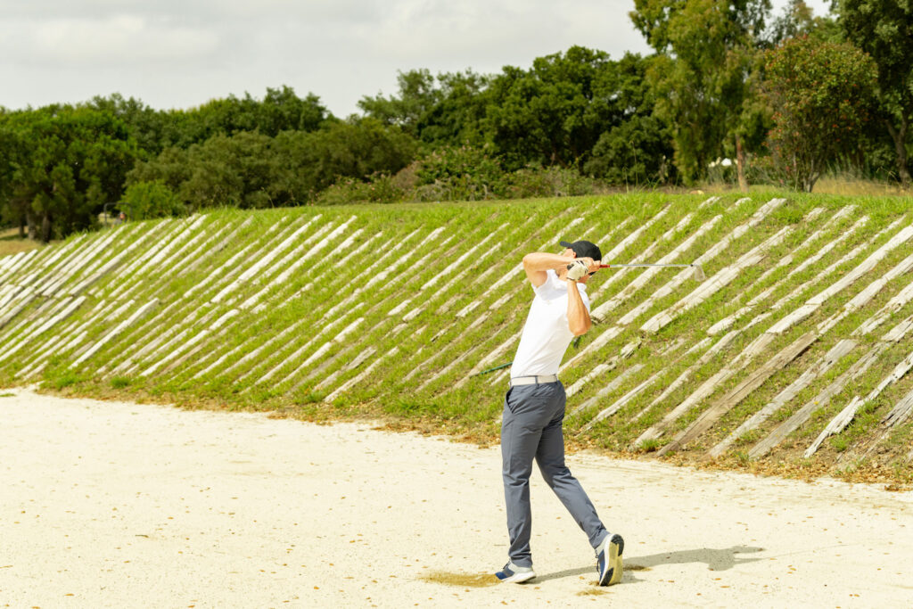 Person playing out of a bunker at San Roque Golf & Resort